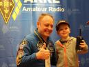 Special ARRL Guest and NASA Astronaut Mike Fincke, KE5AIT, at Dayton Hamvention with 4-year-old Jacob Sanderson, son of Matt, KC9SEM, and Patty, N9PLS, of Glen Ellyn, Illinois.